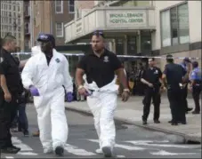  ?? THE ASSOCIATED PRESS ?? Police officers with the Forensics Unit leave Bronx Lebanon Hospital after a gunman opened fire and then took his own life there, Friday, June 30, 2017, in New York.
