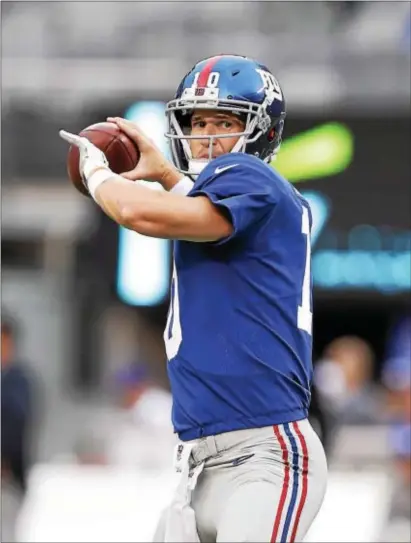  ?? JOHN BLAINE — FOR THE TRENTONIAN ?? Giants quarterbac­k Eli Manning warms up prior to Friday night’s preseason game against the Pittsburgh Steelers. Manning did not play in the game.