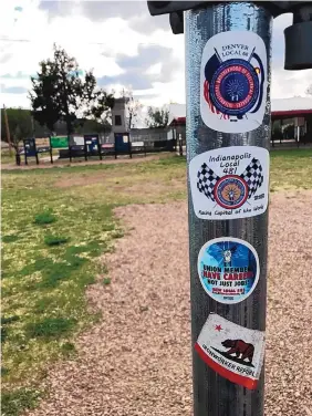  ?? T.S. LAST/JOURNAL ?? People from all over the country visit the site of the Ludlow Massacre, some leaving behind stickers bearing their union affiliatio­n.