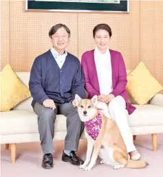  ??  ?? Masako and Naruhito pose for a photograph with their pet dog Yuri at Togu Palace in Tokyo. — AFP photo