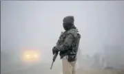  ??  ?? A CRPF jawan stands guard on the chilly and foggy morning in Jammu on Friday, NITIN KANOTRA/HT