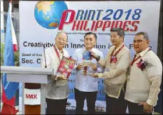  ??  ?? Special Assistant to the President Bong Go receives a plaque of appreciati­on from Printing Industries Associatio­n of the Philippine­s officials during the recent PrintPhili­ppines 2018 event.