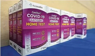  ?? Frederic J. Brown / AFP / TNS ?? Rapid COVID-19 test kits await distributi­on for free to people receiving their COVID-19 vaccines or boosters on Jan. 7 at Union Station in Los Angeles. The FTC offers tips on how to spot fakes.