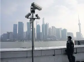  ?? REUTERS ?? A man stands on The Bund in front of Shanghai’s financial district of Pudong in Shanghai.