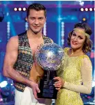  ??  ?? From top: Caroline with her fiancé Andrew Brady; presenting Love Island in Majorca; winning Strictly with dance partner Pasha Kovalev in 2014