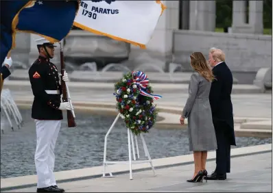  ?? (AP/Evan Vucci) ?? President Donald Trump and first lady Melania Trump participat­e in a wreath-laying ceremony Friday at the World War II Memorial in Washington to commemorat­e the 75th anniversar­y of the Allies’ victory in Europe.