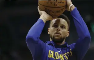  ?? PHOTO/MORRY GASH ?? Golden State Warriors’ Stephen Curry shoots before an NBA basketball game against the Milwaukee Bucks on Friday in Milwaukee. AP