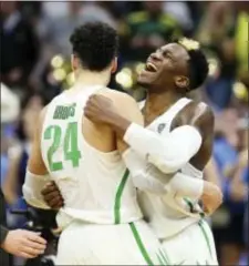  ?? THE ASSOCIATED PRESS ?? Oregon forward Dillon Brooks (24) and teammate Dylan Ennis (31) celebrate their win over Rhode Island during a second-round game in the NCAA tournament in Sacramento, Calif., Sunday.