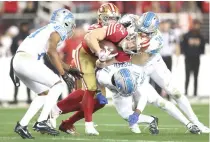  ?? PHOTO BY EZRA SHAW/AFP ?? STOP HIM
Christian McCaffrey (23) of the San Francisco 49ers is hit by Alex Anzalone (34) and Kerby Joseph (31) of the Detroit Lions during the second half in the NFC Championsh­ip Game at Levi’s Stadium on Sunday, Jan. 28, 2024, in Santa Clara, California.