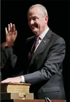  ?? AP PHOTO — SETH WENIG ?? New Jersey Gov.-Elect Phil Murphy takes the oath of office during a ceremony in Trenton, N.J., Tuesday. Murphy became the state’s 56th governor, succeeding Republican Chris Christie after he was sworn in at the War Memorial in Trenton.