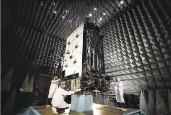  ?? Patrick H. Corkery / Lockheed Martin 2016 ?? Engineers work on the first GPS III satellite at a Lockheed Martin complex outside Denver in 2016. The new system is designed to be more accurate, secure and versatile.