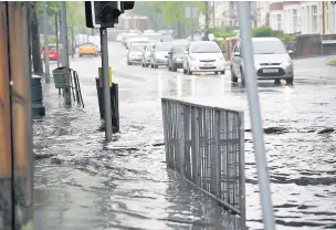  ??  ?? ■ Heavy rain caused problems for drivers in Fairwater, yesterday, above and below