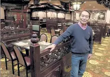  ?? SENTINEL & ENTERPRISE FILE PHOTO ?? After nearly 25 year, Fitchburg's Singapore Restaurant & Lounge is closing, primarily because of the loss of revenues associated to the state's lockdown because of the pandemic. In this file photo from 2017, its owner Wallace Chung stands in the dining area at the restaurant.