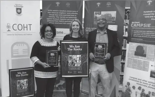  ??  ?? From left to right: Project Manager Deborah Dobbins, Dr. Jenna Bailey, Dr. David Este holding two of the four awards they have been given by the Oral History Associatio­n for their work: the Elizabeth B. Mason Project Award and the Oral History in Nonprint Format Award.