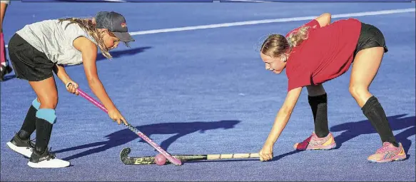  ??  ?? Jayleah Jackson practices an evasive action against and Emily Goodee’s flat-stick defence