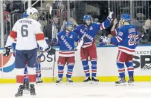  ?? AP PHOTO ?? FEELING BLUE: Mike Zibanejad (second from right) celebrates with teammates after scoring in the Rangers’ 5-2 rout of the Panthers last night in New York