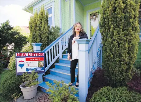  ??  ?? Whitney Garside, of Remax Camosun’s Happy Cat Real Estate, at an Oak Bay home for sale: “We have had to put many safety measures in place. Life as a real estate agent must go on — we need to continue supporting buyers and sellers.”