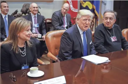  ??  ?? US President Donald J. Trump is flanked by CEO of General Motors Mary Barra, left, and CEO of Fiat Chrysler Automobile­s, Sergio Marchionne, during a meeting with automobile industry leaders in the Roosevelt Room of the White House on Jan. 24, 2017. SHAWN THEW / EPA