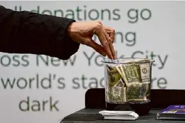  ?? Kathy Willens/Associated Press ?? Money is donated for out-of-work musicians in March 2021 in New York. At tax time, the three biggest potential deductions for most people are mortgage insurance, charitable donations in cash or in property, and eligible state and local taxes.