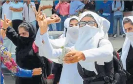  ?? PTI ?? Girl students throw stones at security forces during a clash in Pulwama on Tuesday.