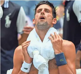  ?? ROBERT DEUTSCH-USA TODAY SPORTS ?? Novak Djokovic coping with the extreme heat while playing Marton Fucsovics of Hungary in a first round match at the U.S. Open.