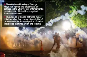  ?? (AFP) ?? Tear gas rises above as protesters face off with police during a demonstrat­ion outside the White House, in Washington, on Monday.