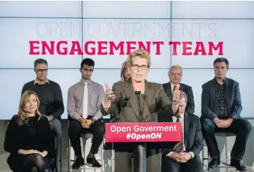  ?? CHRIS YOUNG/THE CANADIAN PRESS ?? Premier Kathleen Wynne announces Ontario’s new ‘Open Government initiative’ Monday — complete with a spelling mistake-festooned podium. Wynne later borrowed a pen and added in the missing letter herself.