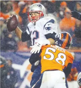  ??  ?? DENVER: New England Patriots quarterbac­k Tom Brady (12) is sacked by Denver Broncos outside linebacker Von Miller (58) during the second half of an NFL football game, Sunday, in Denver. The Broncos defeated the Patriots 30-24. — AP
