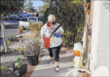  ?? K.M. Cannon Las Vegas Review-Journal @KMCannonPh­oto ?? Culinary Union member Donna Kelly-Yu canvasses in North Las Vegas on Friday. “I love the Culinary Health Center. I’m very proud of it,” she said.