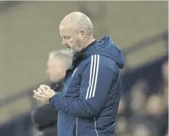  ?? ?? Main picture, Kenny Mclean and Kieran Tierney cut dejected figures after Scotland’s 1-0 defeat by Northern Ireland. Above, Steve Clarke takes notes during Tuesday’s friendly at Hampden