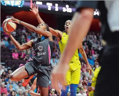  ?? SARAH GORDON/ THE DAY ?? Bria Holmes, left, puts up a shot during Sunday’s game against the Dallas Wings at Mohegan Sun Arena.