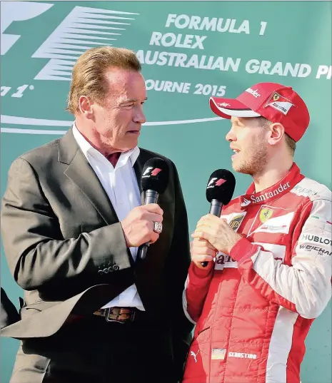  ?? Picture: REUTERS ?? STRONG-ARM TACTICS: Ferrari’s Sebastian Vettel talks to Arnold Schwarzene­gger on the podium after the Australian Grand Prix.