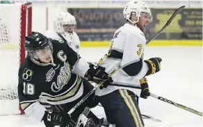  ?? IAN KUCERAK ?? Carter Huber of the Okotocks Oilers, left, gets his stick up on Spruce Grove’s Sean Comrie during Monday night’s action.