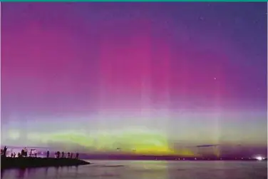  ?? AFP PIX ?? People watching the aurora australis or southern lights caused by a solar storm at Port Phillip Bay in Melbourne on Saturday night.