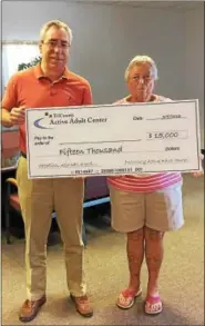  ?? SUBMITTED PHOTO ?? Brian Parkes (left), executive director of the TriCounty Active Adult Center, and Barbara Updegrove, a volunteer and participan­t at the Center, display the check that will be presented to one lucky winner at the conclusion of the 20th annual raffle.