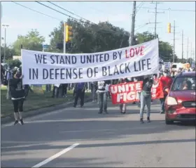  ?? MACOMB DAILY FILE PHOTO ?? Protesters march along Hoover in Warren during a Sept. 20event.