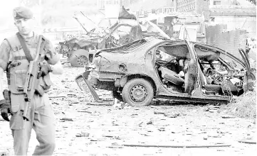  ??  ?? File photo shows civil guards inspect car bomb wreckage after an explosion outside the barracks of Spain’s paramilita­ry Guardia Civil in the northern town of Durango. — AFP photo