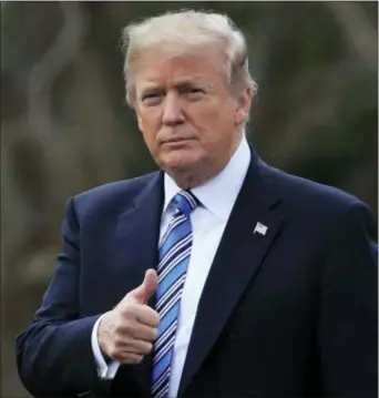  ?? MANUEL BALCE CENETA — THE ASSOCIATED PRESS ?? President Donald Trump gestures as he walks as he leaves the White House, Friday Washington, for a trip to his private Mar-a-Lago resort in Florida. in