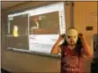 ?? SUSAN GREENSPON – DIGITAL FIRST MEDIA ?? Finley Gust wears the specially created viewing contraptio­n that her mother made from a paper plate. Holes were cut for the eyes and the eclipse viewing glasses slipped through the plate with the purpose of blocking any additional light. Behind her,...