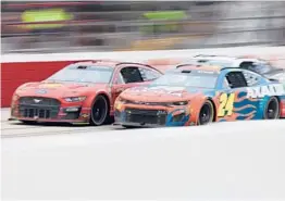  ?? JAMES GILBERT/GETTY ?? Joey Logano and William Byron (24) drive side by side during Sunday’s NASCAR race. Logano sent Byron into the wall on the next-to-last lap en route to the victory.