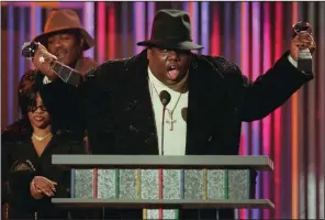  ?? (AP file photo/Mark Lennihan) ?? Notorious B.I.G. clutches his Billboard Music Awards for best rap artist and rap single of the year in a 1995 file photo. The rapper was slain in 1997, a year after the shooting death of rapper Tupac Shakur.