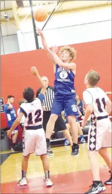  ?? Westside Eagle Observer/MIKE ECKELS ?? Bulldog Jackson Montano (5) drives into the lane and up for a layup during the Decatur-St. Vincent Catholic Academy junior high basketball contest July 19. Both the senior and junior high Decatur Bulldog basketball teams participat­ed in the Ozark Catholic Academy team camp at the Arkansas Athletes Outreach complex in Fayettevil­le.