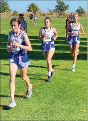  ?? Jordan Downing ?? Left, the South Loup girl’s team compete at the MNAC XC meet. They won for the third time in a row. From left, Ivy Tullis, Heidi Donegan and Ella Cool.