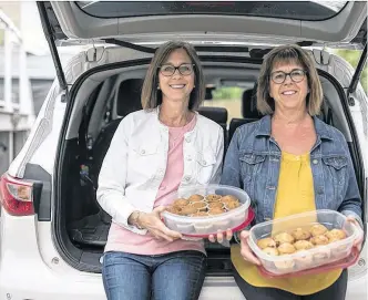  ?? TROY FLEECE • POSTMEDIA ?? Sisters Darlene Hillis (left) and Lorie Matthewson have been baking muffins and collecting muffins from their friends and family to donate to a local outreach centre and several school lunch programs in Regina.