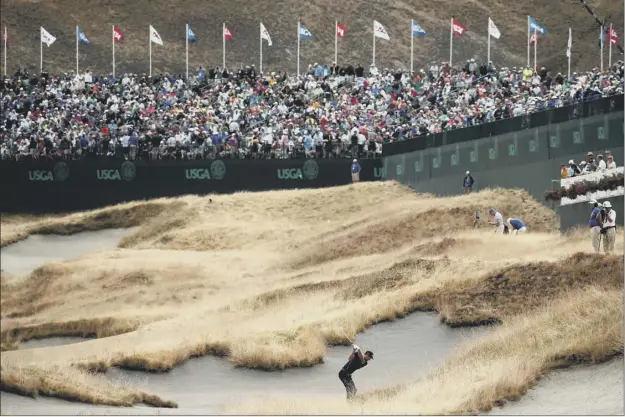  ?? Picture: Getty ?? Dustin Johnson plays his second shot at the 18th hole on his way to sgaring the lead during the first day of the US Open at chambers Bay