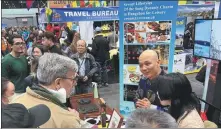  ?? MINGMEI LI / CHINA DAILY ?? Visitors talk with staff at a booth for Hangzhou city at the New York Travel & Adventure Show over the weekend.