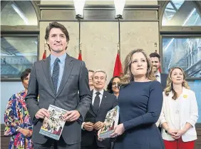  ?? JUSTIN TANG THE CANADIAN PRESS ?? Prime Minister Justin Trudeau, Finance Minister Chrystia Freeland and federal cabinet ministers prepare to table the budget Tuesday on Parliament Hill.