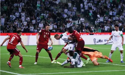  ?? Joosep Martinson/Getty Images, ?? Christoph Kramer of Borussia Monchengla­dbach is challenged by Bayern Munich’s Dayot Upamecano during their 1-1 draw. Photograph: