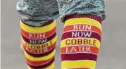  ?? Houston Chronicle ?? A runner wears wears festival socks before taking part in the annual YMCA Run Thru the Woods on Thanksgivi­ng, Thursday, Nov. 23, 2017, in The Woodlands.