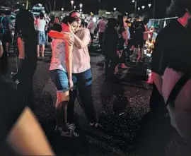  ??  ?? LOCALS comfort one another outside the El Paso Walmart where the shooting occurred. Some say they fear more racist violence or divisions among themselves.